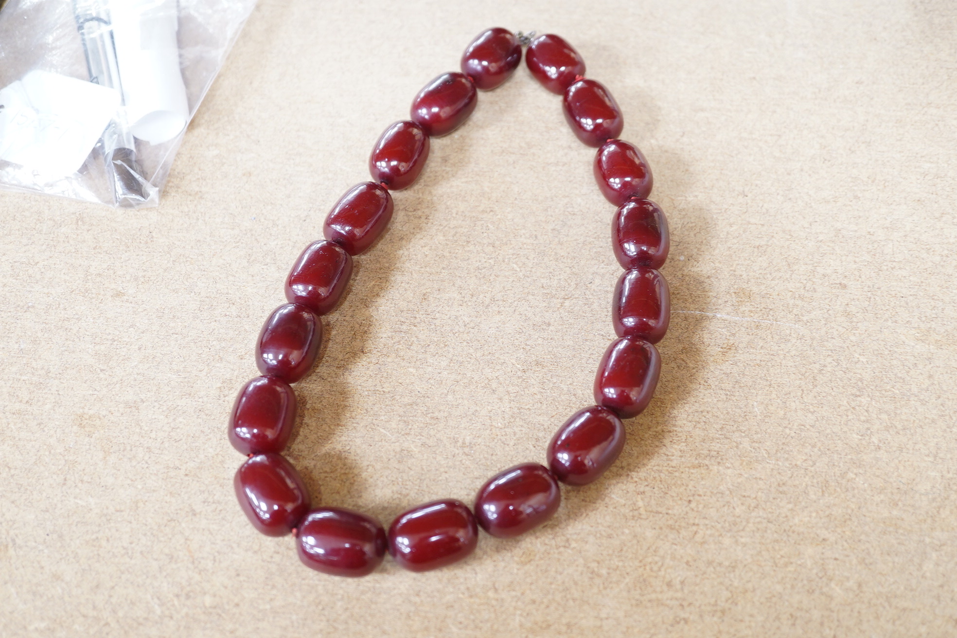 A single strand simulated cherry amber oval bead necklace, 48cm, gross weight 120 grams. Condition - fair